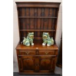 A good quality oak cottage dresser with open plate rack above two frieze drawers and twin panelled