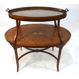 An Edwardian Sheraton Revival crossbanded satinwood two tier stand, of oval form,