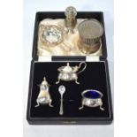 A cased silver three-piece condiment set with blue glass liners, Sheffield 1931,