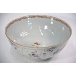 A famille rose punch bowl decorated on the exterior with shaped floral panels and insects;
