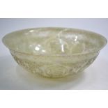 A translucent jade bowl of circular form, decorated on the exterior with shou or other symbols,