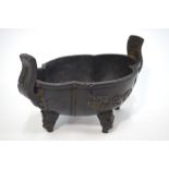 A metal alloy incense burner of quatrefoil form with four mythological head decorated feet and