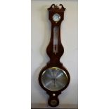 An early 19th century flame mahogany wheel barometer with silvered thermometer scale,