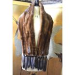 A mid brown mink fur stole, each end embellished with five tails, retailed by Eric's Furriers,