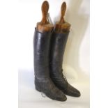 A pair of vintage gentleman's black leather military boots with three-section boot trees