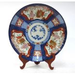 A Japanese Imari dish of circular form,