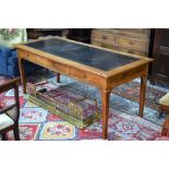 A continental fruitwood library table having a rectangular tooled leather inset surface,
