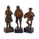 Three Black Forest carved wood figures - bootmaker, horn-player and old man,