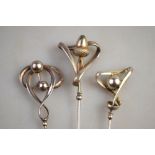 Three Art Nouveau hat pins, one featuring acorn stamped P&T,