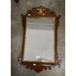 A 19th century fret cut mirror surmounted by a gilt ho-ho bird,
