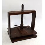 A 19th century mahogany/fruitwood book/flower press with turned handles,