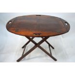 A 19th century mahogany butler's tray on folding stand,