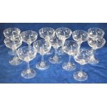 A set of thirteen champagne bowls with faceted knops and stem raised on a domed foot, 13.