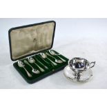 A small silver cup and saucer with scroll handle and stemmed foot, Thomas Hazelwood & Co.