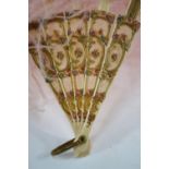 A pink ostrich-feather fan on carved, painted and gilded sticks,
