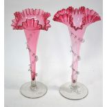 Two Victorian cranberry glass flutes with frilled rims, 29.
