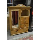 A Victorian waxed pine miniature wardrobe with mirrored door and four drawers,