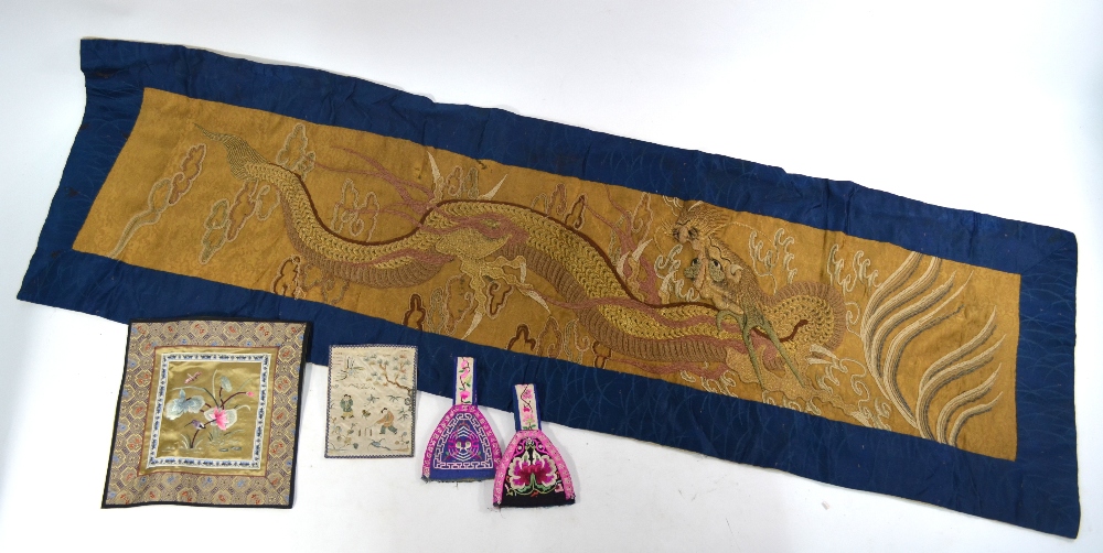 Four small Chinese textiles, together with a dragon decorated,