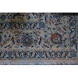 A large Persian Nian carpet, the flowering vine design on traditional off white/camel ground,