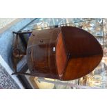 A Victorian mahogany corner washstand with hinged top enclosing vacant apertures for wash bowl/jug