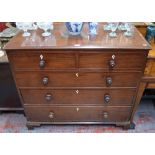A 19th century mahogany chest of two short over three long graduated drawers having original turned