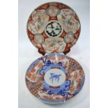 Two large Japanese Imari dishes: one decorated in underglaze blue at the centre with a kirin;