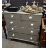 A grey painted pine chest of two short over three long drawers raised on shaped bracket feet