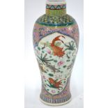 A famille rose vase decorated with fan-tailed goldfish and other fish beside lotus and aquatic