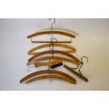 A collection of seven branded vintage wooden clothes hangers (to/w folding example with brushes)