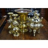 A brass tripod incense burner with pierced domed cover and mythological animal finial,