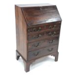 A George III mahogany bureau of diminutive proportions,