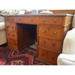 A late Victorian walnut twin pedestal desk, with green leather inset top above nine drawers,