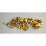 A yellow metal stone set bracelet stamped 585 having sixteen various charms attached and 1892