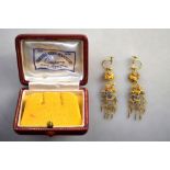 A pair of chandelier type yellow metal earrings inset with Kingfisher feathers,