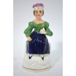 A 19th century hollow primitive Staffordshire model of a seated young Queen Victoria, 11.