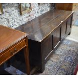 An 18th century oak coffer with four fielded panel front, on stile feet,