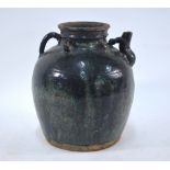 A Chinese mottled green glazed, stoneware ewer with short curved spout and five pierced handles,