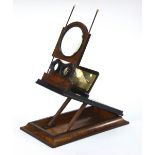 A Victorian stereo graphoscope of typical rectangular and folding form with central magnifying