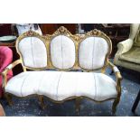 A French giltwood framed three serpentine form salon sofa with linen upholstery,