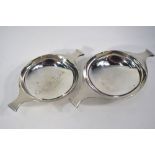 A graduated pair of Edwardian Scottish silver quaiches with flared handles and foot-rims,