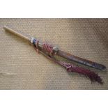 A Pacific tribal sword with 50 cm slightly curved blade, wooden handle bound with plaited grass,