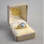 An aquamarine and diamond oval cluster ring having pierced diamond set shoulders,