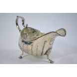 A George III Irish silver pot-bellied sauce boat with nail-pinch decoration,