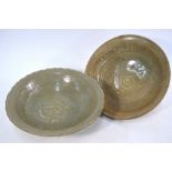 Two provincial celadon bowls of circular form: one with foliate rim and central flower head,