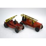 Two clockwork tinplate fire engines with extending ladders,
