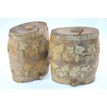 A pair of 19th century saltglaze stoneware oval wine barrels decorated with applied grapes and vine