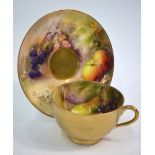 A Royal Worcester tea cup and saucer hand-painted by Ricketts with fruit on a naturalistic ground,