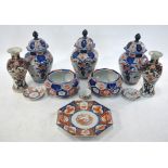 A 'garniture' of five associated vases, comprising: a set of three of octagonal,