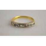 An 18ct yellow gold eternity ring set with three baguette and four brilliant cut diamonds,