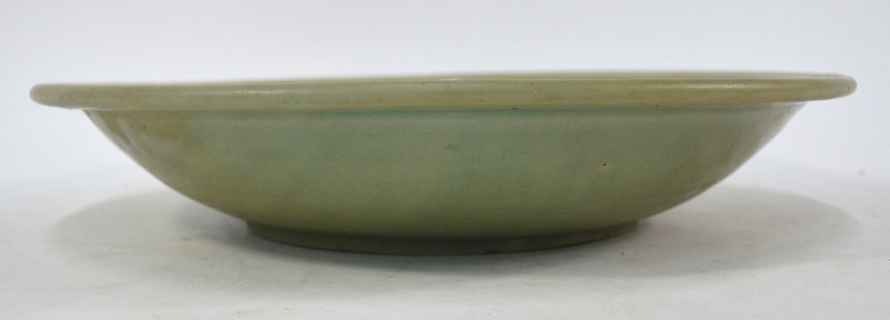 A Ming celadon dish of circular form, decorated at the centre with a floral spray, - Image 4 of 6